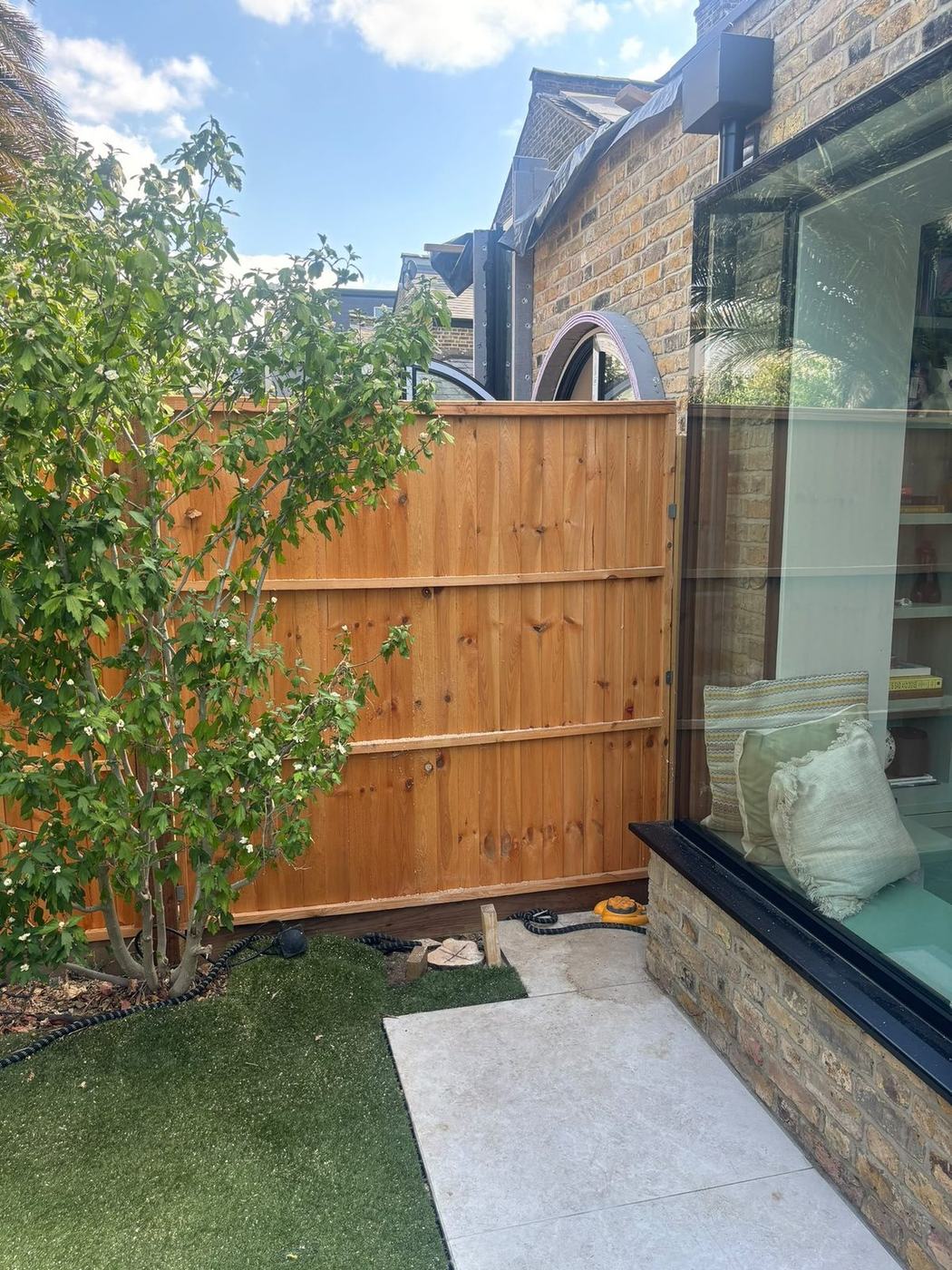 A new lawn laid beside a fresh fence