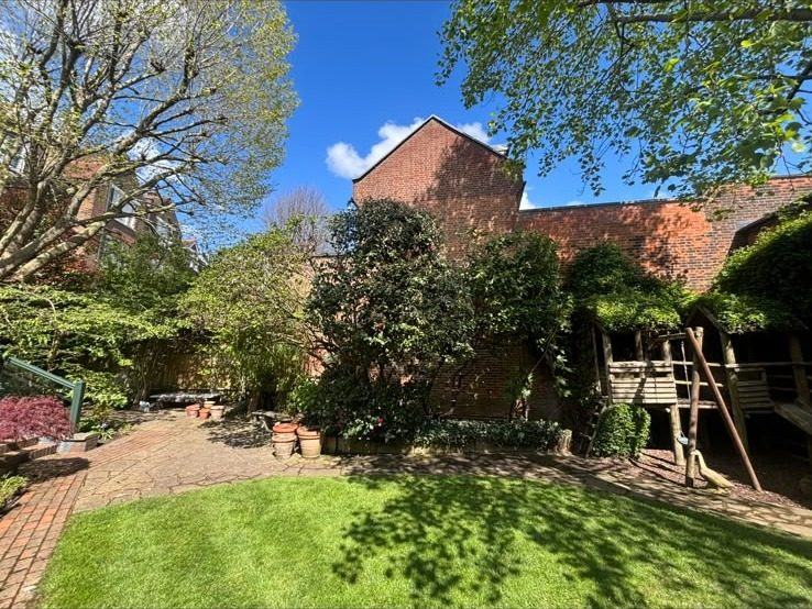 Lawn and planted borders in a walled garden